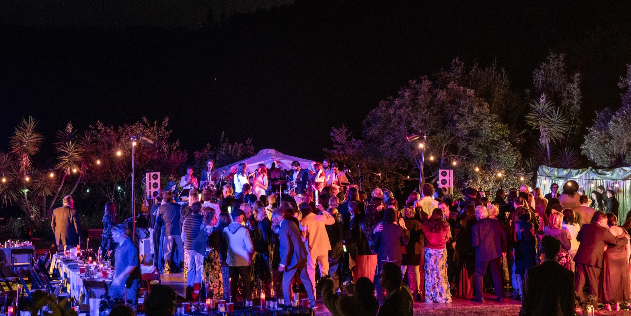 A full dance floor and live band performing through a Hi-Tone sound system at night